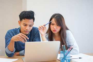 group of asian employee working research final project on laptop in private meeting office room 