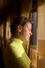 Young minded woman traveling by train and looking out the window