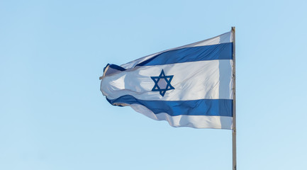 Israel flag in the wind isolated against the sky