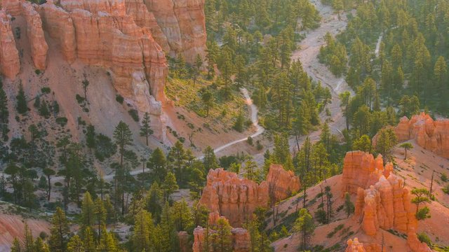 Rays of the sun illuminates orange cliffs. Panoramic view at the cliffs. Nature video. Amazing mountain landscape.Bryce Canyon National Park. Utah. USA. 4K, 3840*2160, high bit rate, UHD