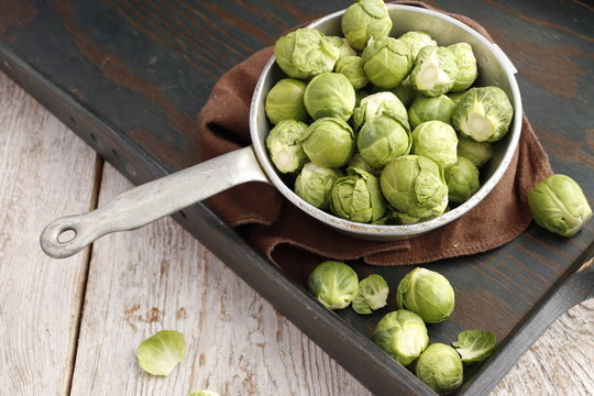 Raw organic Brussels sprouts in a colander
