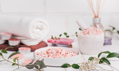Obraz na płótnie Canvas Handmade Salt Peach Scrub With Argan Oil. Himalayan Salt. Toiletries, Spa Set with candles and white towel