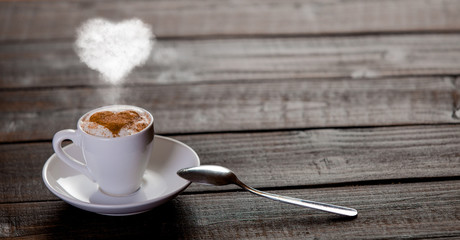 Cup of coffee with ehart shape steam