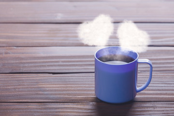 Obraz na płótnie Canvas Cup of coffee with heart shapes steam