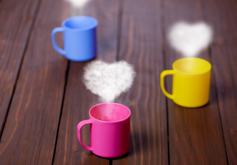 Three cups of tea or coffee with heart shapes