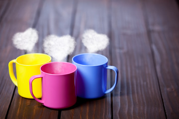 Obraz na płótnie Canvas Three cups of tea or coffee with heart shapes