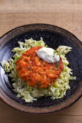 Salmon burgers nestled on a bed of coleslaw. Salmon fish cake