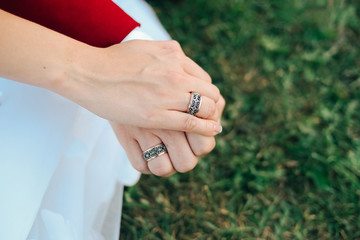  bride with the groom hold hands show the rings
