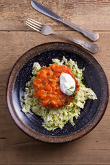 Salmon burgers nestled on a bed of coleslaw. Salmon fish cake. View from above, top