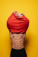 Young asian boy taking off the t-shirt.
