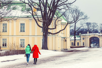 Mom and daughter in the park in the winter at sunset in Russia