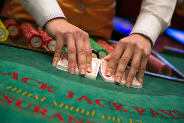 Closeup of hands shuffling cards casino