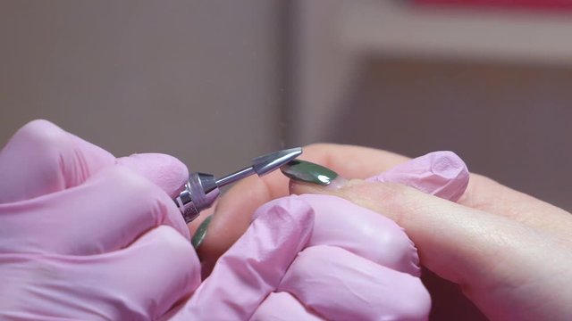 Slow motion. hardware manicure. removal of nail polish with a rotating nail file. HD