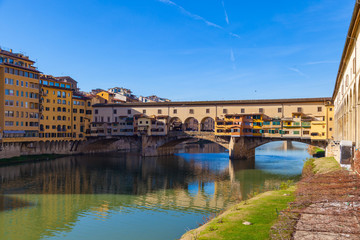 Fototapeta na wymiar Arno river, houses and old Ponte Vecchio bridge, Florence, Tuscany, Italy
