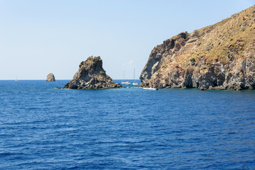 Fototapeta na wymiar Yachts at the rocky coast of Lipari Island