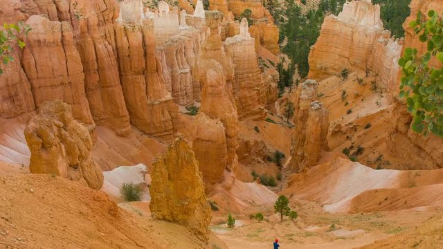 Panoramic view at the cliffs. Spectacular ravine. Tourists walking along the trail. Nature video. Amazing mountain landscape.Bryce Canyon National Park. Utah. USA. 4K, 3840*2160, high bit rate, UHD