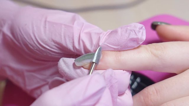 Slow motion. hardware manicure. removal of nail polish with a rotating nail file. HD