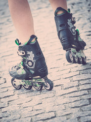 Fototapeta na wymiar Woman legs wearing roller skates