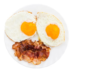 Plate with fried eggs and bacon on white background