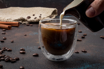 In black coffee poured milk