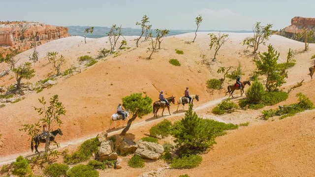 Spectacular view at the cliffs. Tourists riding on horses along the trail. Nature video. Amazing mountain landscape. Bryce Canyon National Park. Utah. USA. 4K, 3840*2160, high bit rate, UHD