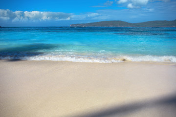 Fototapeta na wymiar sea surf, blue clear water and white sand