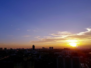 Fototapeta premium Beautiful sunset with silhouette of buildings over Johor Bahru's cityscape in Malaysia