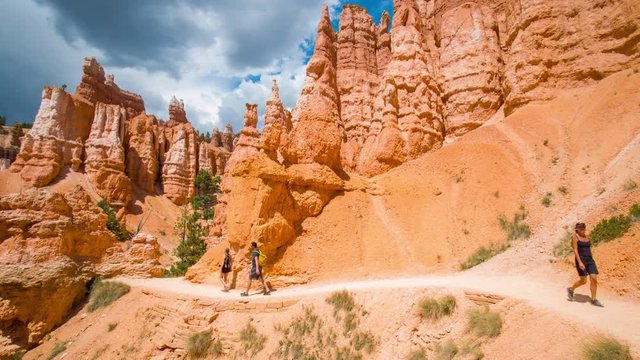 Narrow footpath among yellow cliffs. Spectacular view at the cliffs. Tourists are walking along the trail. Bryce Canyon National Park. Utah. USA. 4K, 3840*2160, high bit rate, UHD