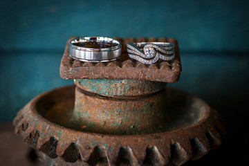 Silver wedding rings on vintage, rusted gears