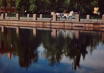 Pushkin city view with blue sky with reflections on the water and coach