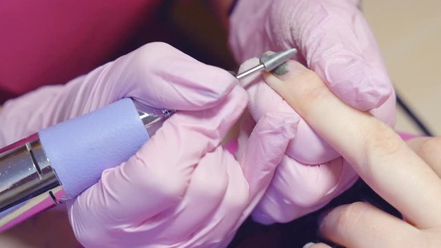 Slow motion. hardware manicure. removal of nail polish with a rotating nail file. HD