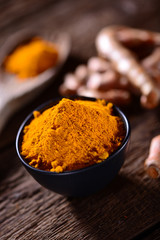 Turmeric spice on old wooden table