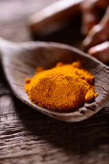 Turmeric spice on old wooden table