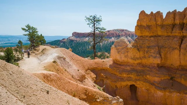 Tourists are walking high in the mountains. Spectacular view at the cliffs. Amazing landscape. Nature video. Bryce Canyon National Park. Utah. USA. 4K, 3840*2160, high bit rate, UHD
