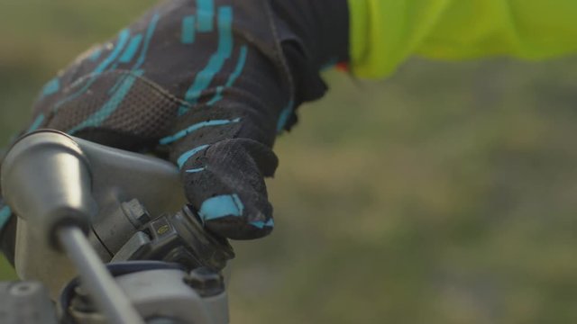 Close up of a rider's hand on a motocross handlebar