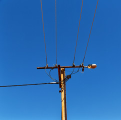 power line with electrical pole in the clear sky