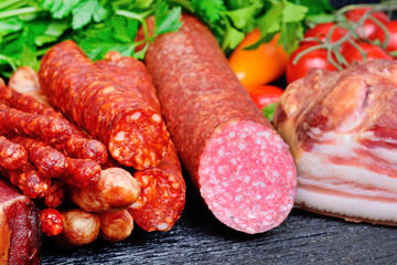 Delicious sausages with colorful peppers and cherry tomatoes