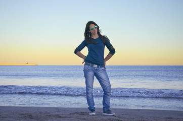 Woman posing on the beach at sunset