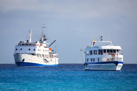 Typical tourist vessels anchored at Gardner Bay near Espanola Island, Galapagos National park, Ecuador