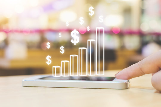 Business analytics and online financial technology (fintech) concept. Hand of female pushing smartphone device