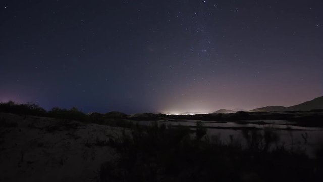 Time lapse - Nigh with stars at 'Joaquina's' Dunes. Camera movement revealing lagoons in the background.  Florianópolis, Santa Catarina / Brazil