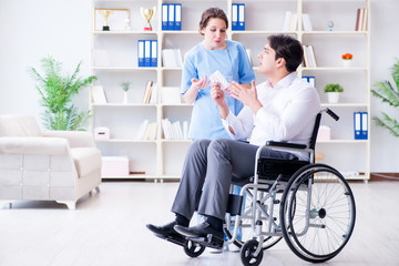 Disabled patient on wheelchair visiting doctor for regular check