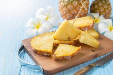 fresh sliced pineapple on wood block