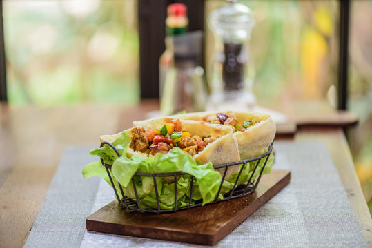 Pork and Chicken Curry Roti naan bread wraps at indian food restaurant.