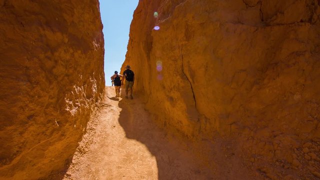 People walking along the narrow trail. Nature video. Amazing mountain landscape. Spectacular view at the cliffs. Bryce Canyon National Park. Utah. USA. 4K, 3840*2160, high bit rate, UHD