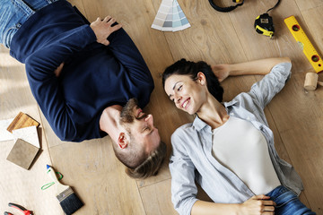 Family lying on wooden floor