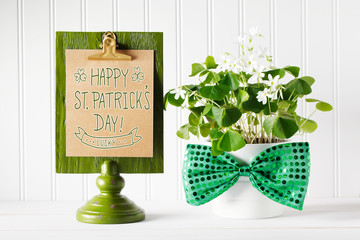 Saint Patricks Day message board with shamrock in white pot