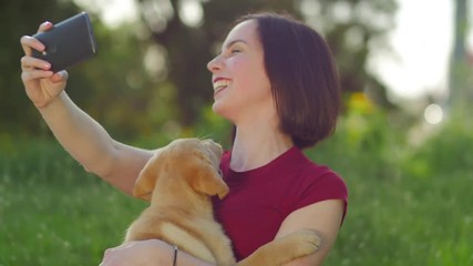 Labrador puppy licking a woman's face