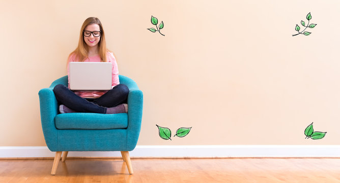 Green Leaves with young woman using her laptop in a chair
