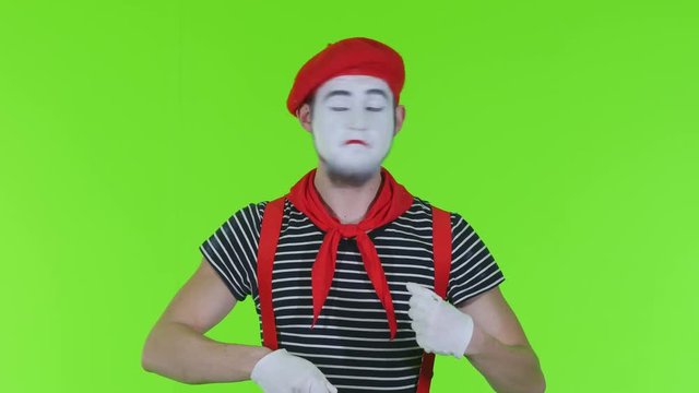 Male mime is eating on a green background